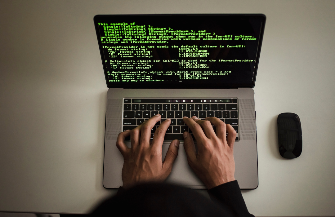 man coding on laptop